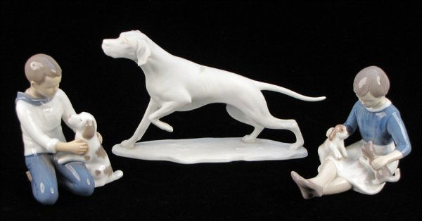 BING & GRONDAHL PORCELAIN FIGURE OF A GIRL WITH: BING & GRONDAHL PORCELAIN FIGURE OF A GIRL WITH KITTEN AND PUPPY, 2333. Together with a Bing & Grondahl porcelain figure of a boy with a puppy, 2334, and a Kaiser porcelain figure of a dog