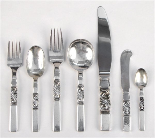 GEORG JENSEN STERLING SILVER FLATWARE SERVICE I: GEORG JENSEN STERLING SILVER FLATWARE SERVICE IN THE SCROLL PATTERN. Comprised of nine dinner forks, nine salad forks, nine dessert/oval soup spoons, nine teaspoons, eight demitasse spoons, nine dinne
