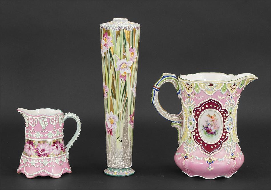 Pink Nippon Moriage Pitchers.: Pink Nippon Moriage Pitchers. Consisting of a large and small pink Nippon Moriage pitchers, decorated a floral design on panels and bands. Together with a cylindrical Nippon Moriage vase decorated wit