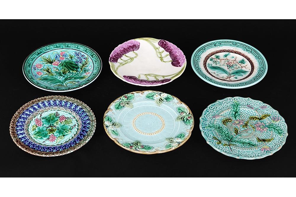 A Group of Six Majolica Plates.: A Group of Six Majolica Plates. Consisting of an art nouveau Sarreguemines purple floral plate, a floral and berry plate marked Sarreguemines, two plates marked U and C S, a V and B S plate and an unm