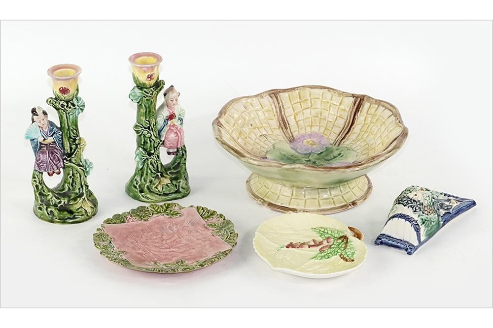 A Group of Decorative Majolica.: A Group of Decorative Majolica. Consisting of a pedestal compote, a pair of candlesticks with an oriental male and female figure, a small leaf form plate marked Carlton Ware and a pink tile plate mark