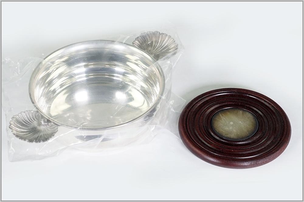 A Buccellati Sterling Silver Wine Coaster.: A Buccellati Sterling Silver Wine Coaster. Round coaster with shell form handles and an inset wood and silver insert. Silver coaster is in original sealed plastic packaging. With box Wt including plas