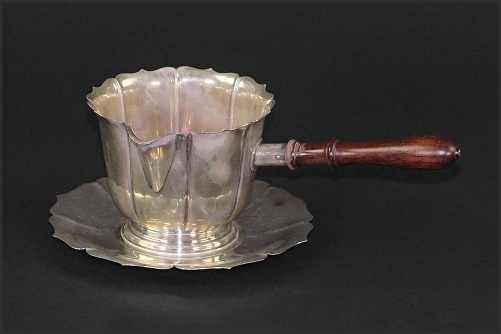 A Cartier Sterling Silver Sauce Boat with Underplate.: A Cartier Sterling Silver Sauce Boat with Underplate. Wood handled sauce boat and underplate are both stamped "from / Early Dublin Design / circa 1720 / Cartier Sterling / 743 D". Monogrammed CFD alon