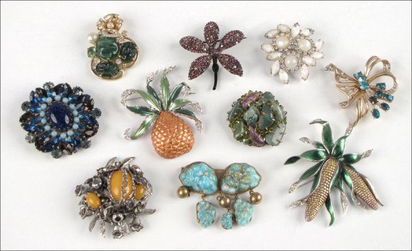 GROUP OF TEN BROOCHES.: GROUP OF TEN BROOCHES. Comprised of one Miriam Haskell faux amber, rhinestone, and seed bead cluster, one Boucher enamel and rhinestone pineapple, one Boucher enamel and rhinestone corn cob, one BSK p