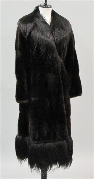 THOMAS MCELROY BROWN MINK COAT.: THOMAS MCELROY BROWN MINK COAT. Trimmed with black fur at the shawl collar and along the bottom Approximately a size 4
