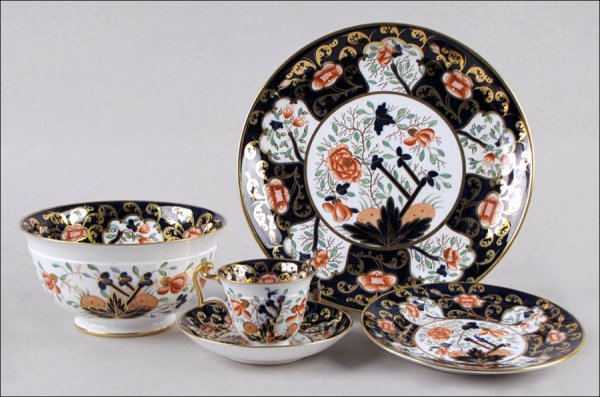 COALPORT GILT AND PAINTED PORCELAIN PARTIAL TEA: COALPORT GILT AND PAINTED PORCELAIN PARTIAL TEA SERVICE. Comprised of eighteen saucers, seventeen teacups (twelve of one style, five of another), one open bowl, twelve tea plates, and two dinner plate
