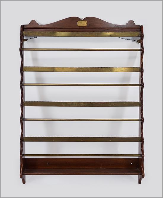 A Mahogany Wall Mount Rack.: A Mahogany Wall Mount Rack. Converted from a paper dispenser, with five tiers and saw tooth edges. The mounted brass plaque reads "J. Balfour, 5th H.L.I., C. Coy 1042". The plaque possibly commemorati