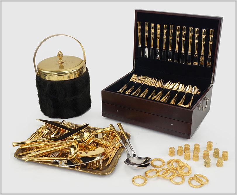 An Assembled Goldtone Bamboo Flatware Service.: An Assembled Goldtone Bamboo Flatware Service. Service for twelve with serving pieces. Together with goldtone metal bamboo napkin rings, salt shaker, a rectangular tray and an ice bucket with faux fur