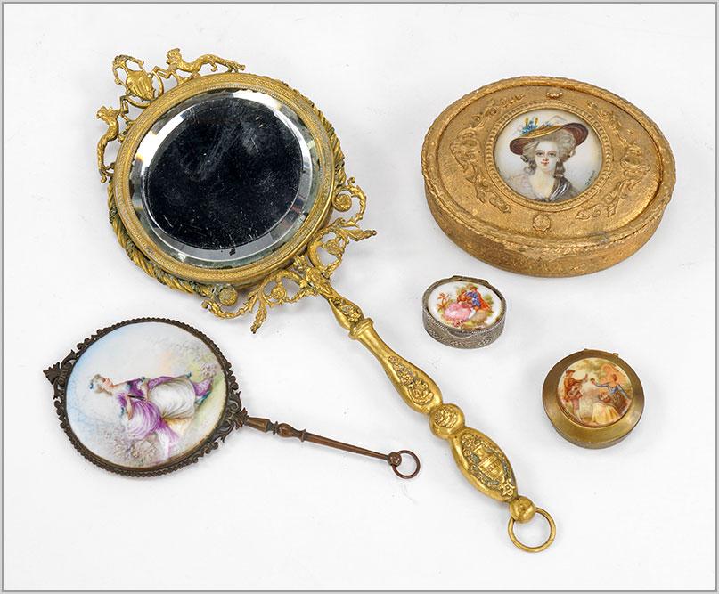 Gilt Metal Portrait Mirrors and Dresser Boxes.: Gilt Metal Portrait Mirrors and Dresser Boxes. Consisting of two beveled glass small hand mirrors, one with a small portrait and the other with a painted seated lady. Together with two small pill boxe