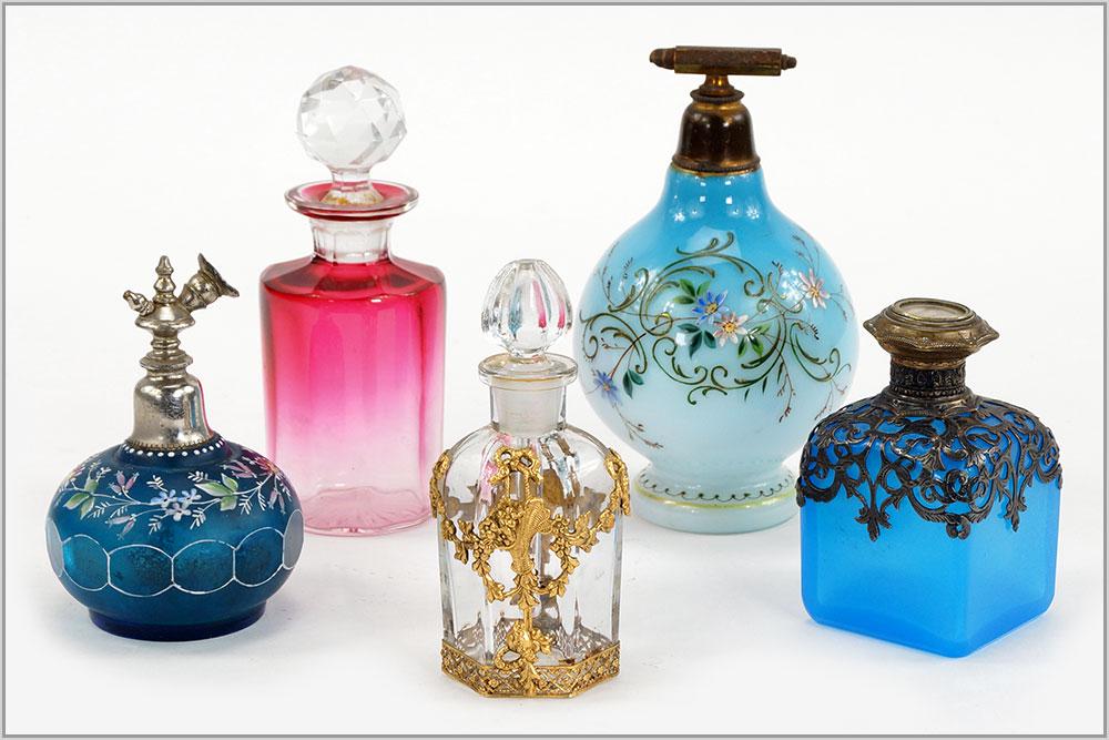Five Victorian Perfume and Cologne Bottles.: Five Victorian Perfume and Cologne Bottles. Consisting of a blue opaline cologne bottle with silverplate overlay, a gilt metal overlay and crystal perfume bottle, two blue enamel atomizer perfume bott