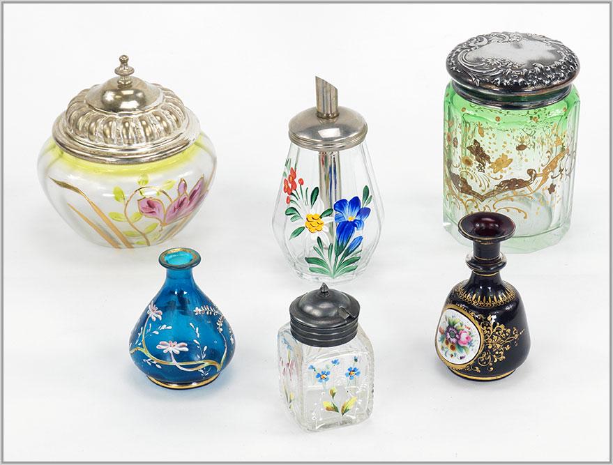 A Group of Victorian Glass Decorative Items.: A Group of Victorian Glass Decorative Items. Consisting of two biscuit jars, a sugar shaker, two vases and a jar. The dark gold and enamel vase is ox blood red, the blue enamel vase is possibly Moser 