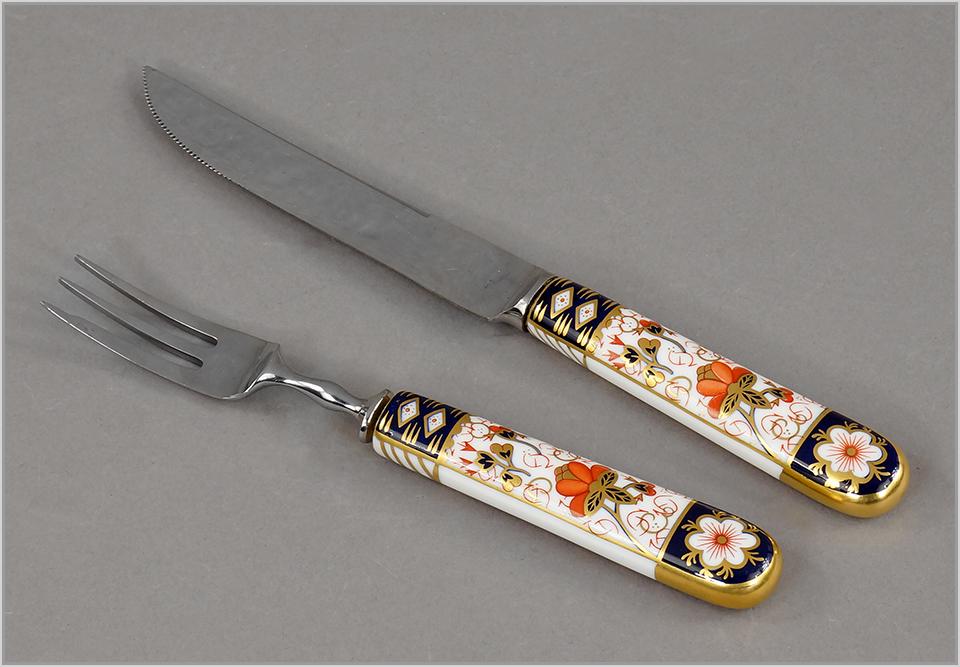 A Royal Crown Derby Porcelain Partial Flatware Service.: A Royal Crown Derby Porcelain Partial Flatware Service. Old Imari pattern. Comprising five pastry forks (length: 7"), six steak forks (length: 7 1/8") and six steak knives (length: 8 1/2"). With fitte