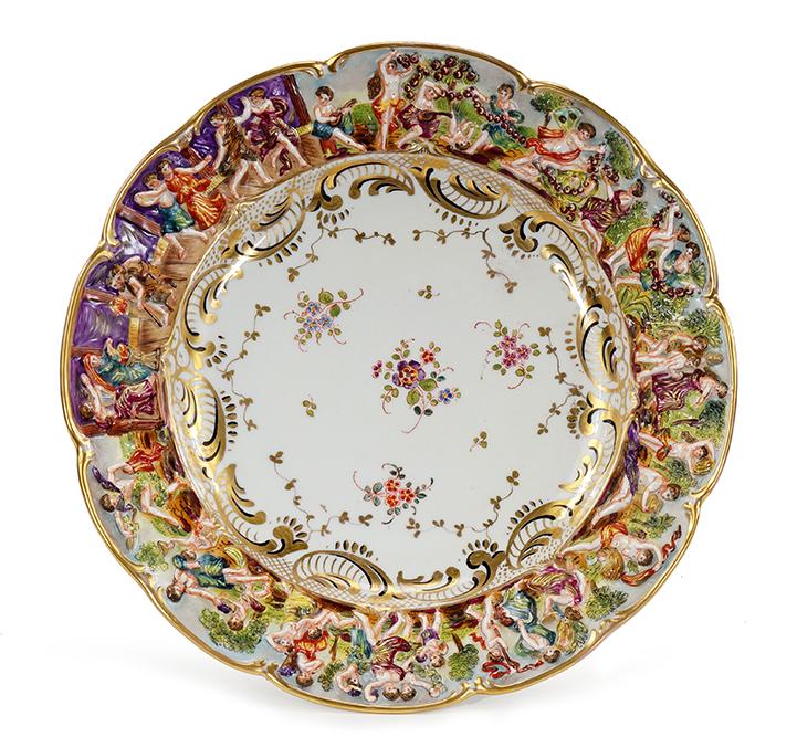 A Set of Twelve Capodimonte Porcelain Plates.: A Set of Twelve Capodimonte Porcelain Plates. Hand painted porcelain plates with a relief scene along the border depicting a Bacchanal procession Diameter: 9 3/4"