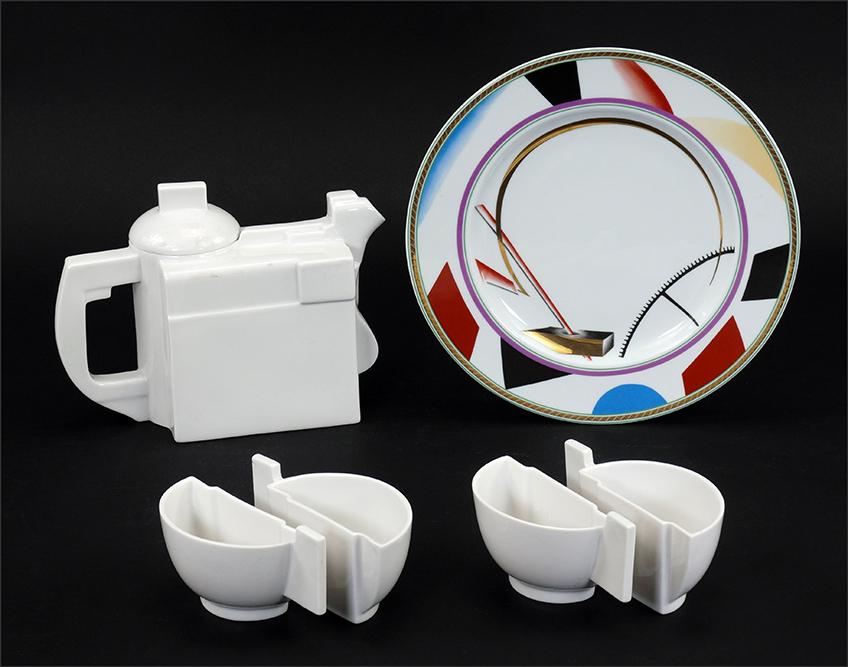 A Russian Lomonosov Porcelain Tea Service.: A Russian Lomonosov Porcelain Tea Service. Comprising a teapot and four "halved" teacups after a design by Kazimir Malevich. With fitted box. Together with a Lomonosov porcelain plate after a design b