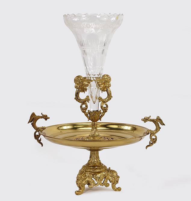 A Centerpiece.: A Centerpiece. Brass footed centerpiece with dragons along either side of the bowl and a cut glass trumpet vase insert. Vase and centerpiece may be a marriage 21" x 16"