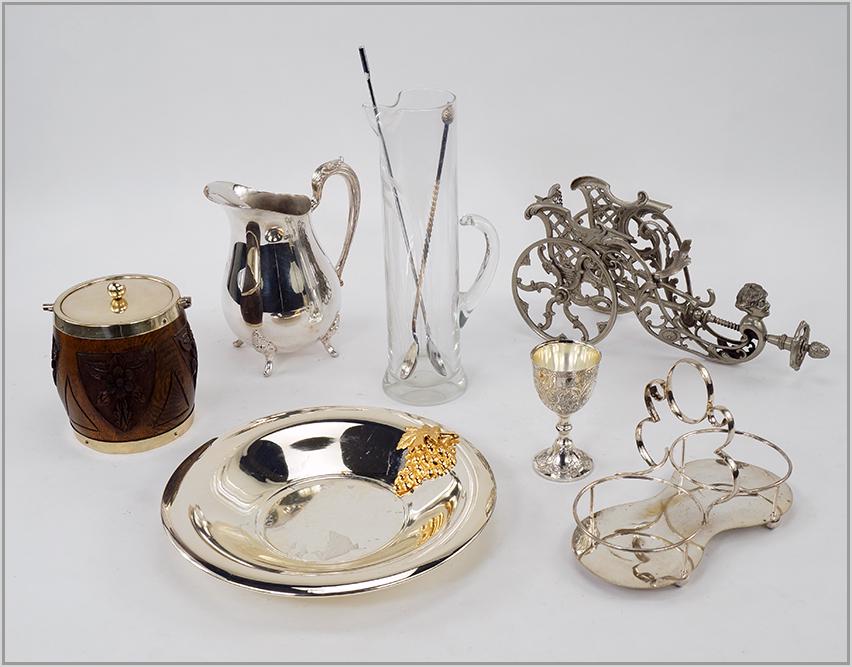 A Collection of Bar Items.: A Collection of Bar Items. Comprising a metal chariot form wine bottle trolley, a glass pitcher, a silverplate pitcher, two bar spoons, a set of twelve silverplate goblets, a silverplate two bottle de