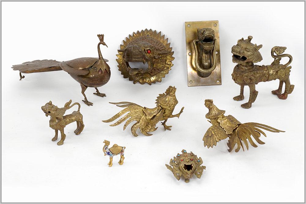 Two Brass Foo Lions.: Two Brass Foo Lions. Together with a pair of brass table peacocks, a brass peacock form incense burner, a dragon form door knocker, a brass wall mount animal's head, a cloisonne and brass camel and a 