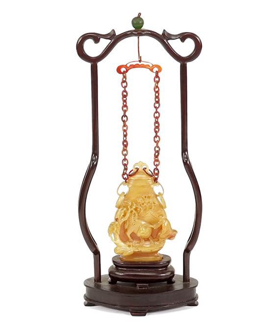 A Chinese Carved Hornbill Snuff Bottle.: A Chinese Carved Hornbill Snuff Bottle. Carved with a decoration of a figure with an ox, bearing an inscription and artist mark on the verso, set in a fitted wood display stand Bottle height: 3" Stand