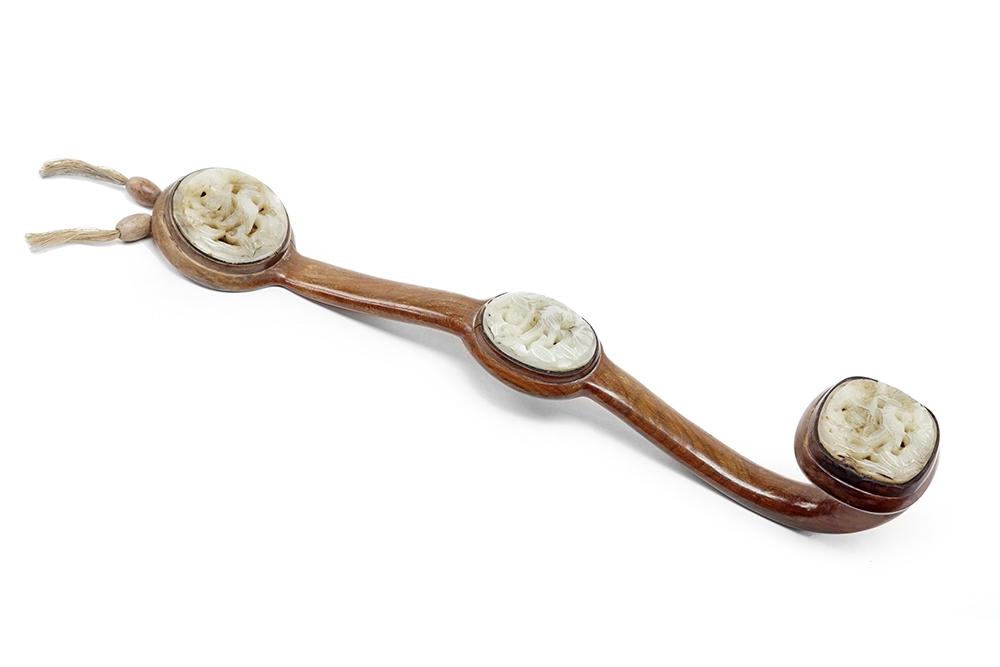 A Chinese Ruyi Scepter.: A Chinese Ruyi Scepter. Wood frame with mounted carved jade medallions Length: 14"