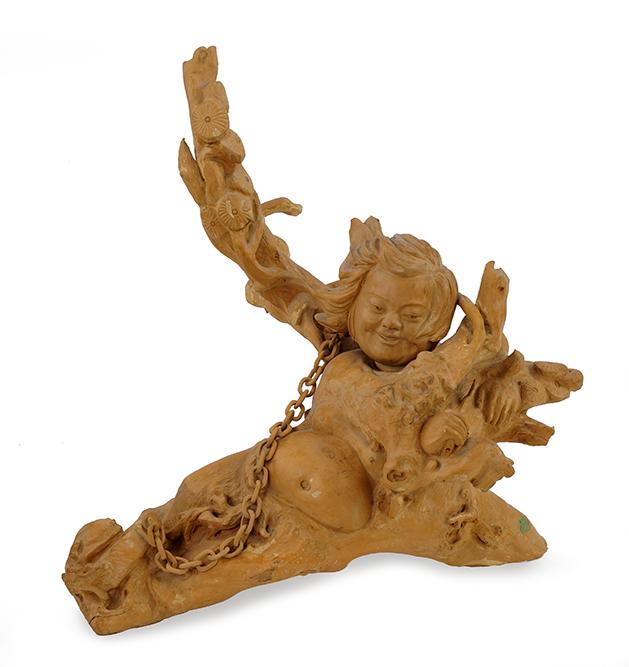 A Balinese Wood Carving.: A Balinese Wood Carving. Carved wood sculpture depicting a reclining figure with wood "chain" link 21 1/2" x 21" x 10"