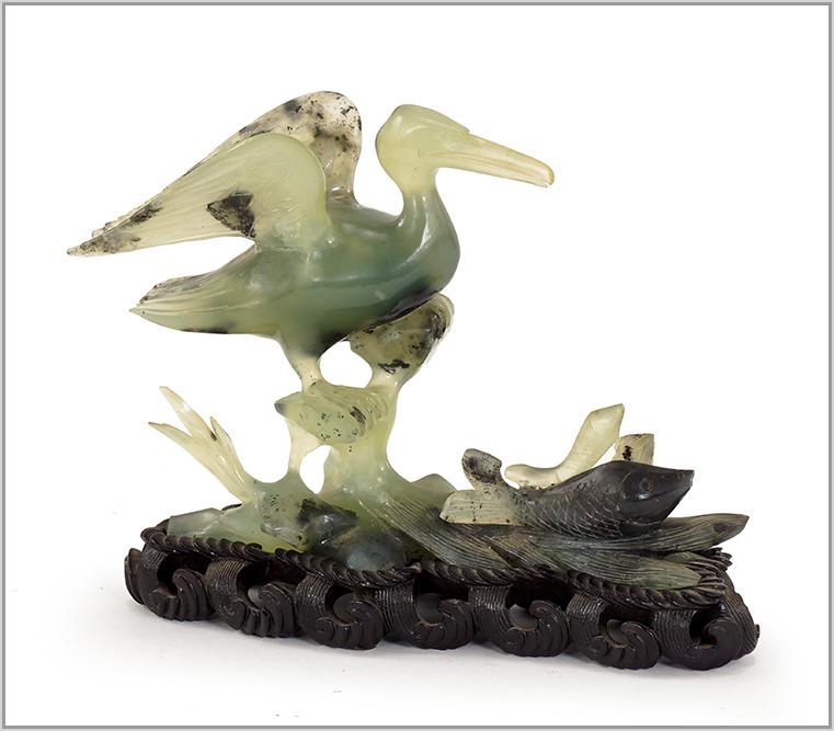 A Chinese Carved Jade Figural Group.: A Chinese Carved Jade Figural Group. Depicting a sea bird and fish, with a fitted, carved wood stand Jade: 6 1/2" x 10" x 3"