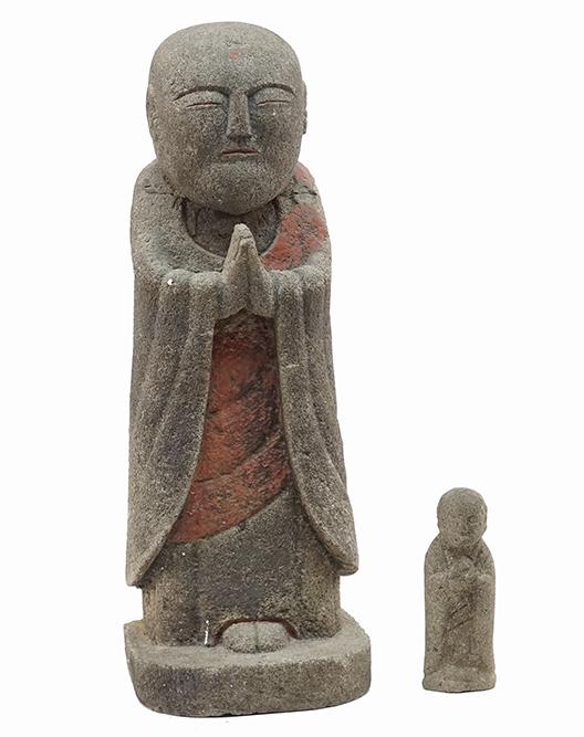 A Carved Stone Figure of a Buddhist Monk.: A Carved Stone Figure of a Buddhist Monk. Bearing red painted detailing. Together with a smaller carved stone figure of a monk (height: 6") 19 1/4" x 7" x 6"