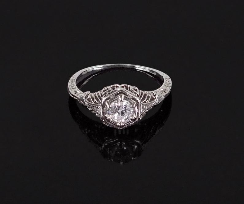 A Diamond Ring.: A Diamond Ring. 14 karat filigree white gold mounting contains one prong set round diamond which is G color, I1 clarity and weighs approximately .40 carat Size: 6 Wt: 2.1 grams