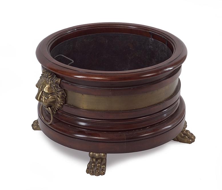 A Henredon Georgian Style Mahogany Planter.: A Henredon Georgian Style Mahogany Planter. Bearing a brass band to the perimeter, lion form handles, and raised on paw feet. With metal liner 16 1/2" x 28"