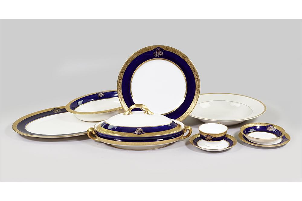 A Lenox Gilt Cobalt Porcelain Dinner Service.: A Lenox Gilt Cobalt Porcelain Dinner Service. Comprising ten dinner plates, twelve salad plates, twelve bread plates, twelve teacups with saucers, nine fruit bowls, one open vegetable bowl, one covere