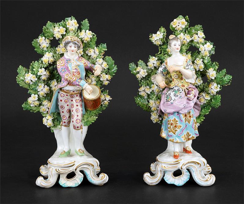 A Pair of Chelsea Porcelain Bocage Figures.: A Pair of Chelsea Porcelain Bocage Figures. Depicting a gentleman playing a drum and a lady with arms outstretched Height: 10 1/4"