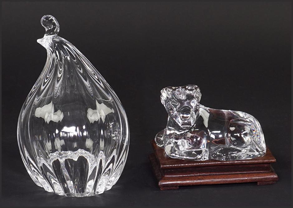 A Baccarat Crystal Seated Bull.: A Baccarat Crystal Seated Bull. With a fitted wood stand. Together with a Steuben quail. Both with maker's marks Quail height: 5 3/4"