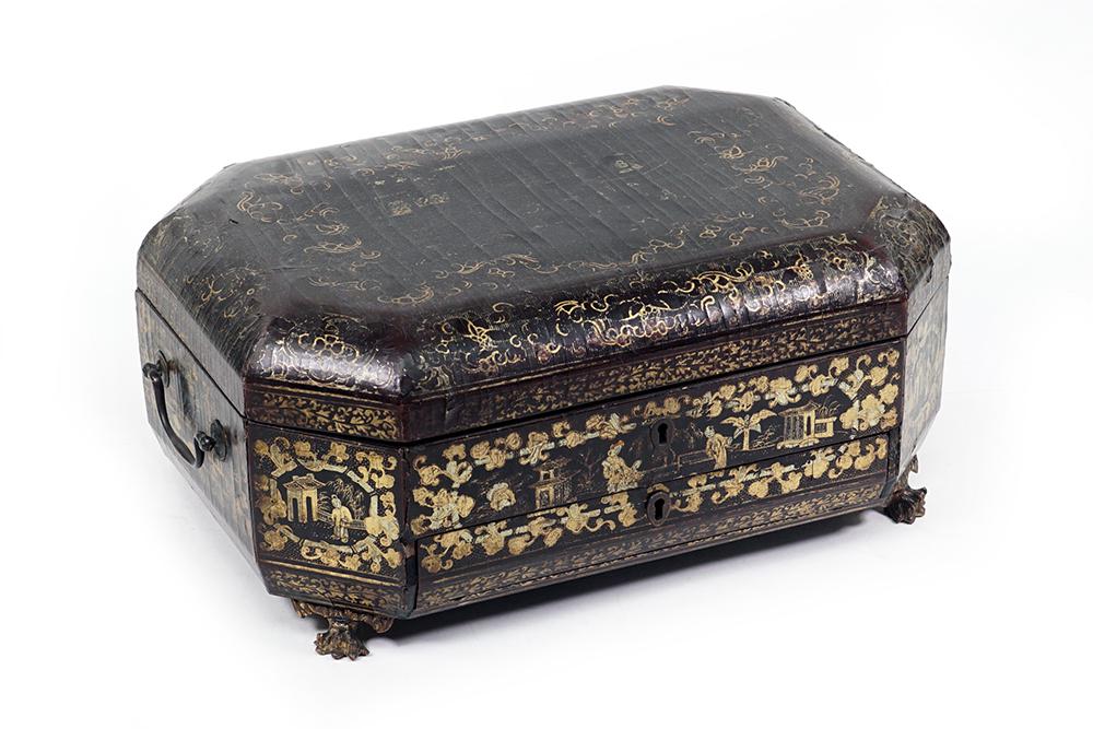 A Chinese Export Lacquered Sewing Box.: A Chinese Export Lacquered Sewing Box. Footed box with several internal compartments and a collection of bone sewing implements 6 1/2" x 14 1/2" x 10"