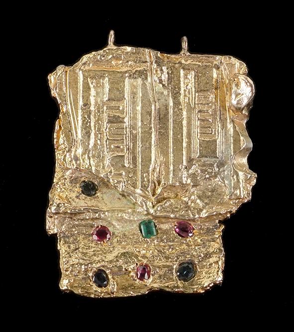 Igael Tumarkin (Israeli/German, B. 1933) A Pendant.: Igael Tumarkin (Israeli/German, B. 1933) A Pendant. Gilt bronze pendant mounted with rubies, sapphires and an emerald. Signed on the reverse 3 1/4" x 2 1/2" Wt: 126.6 grams