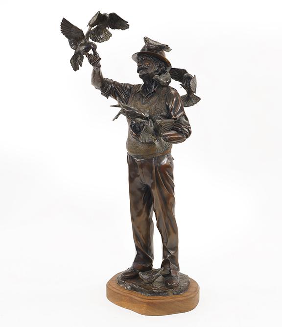 George Wayne Lundeen (American, B. 1948) Feeding the: George Wayne Lundeen (American, B. 1948) Feeding the Birds. Bronze sculpture with dark brown patina, inscribed 'G.W. Lundeen 1981' and numbered 21/21, set on a wooden base Bronze height: 30 1/4" Overa