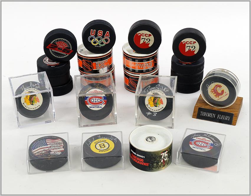 A COLLECTION OF SIGNED AND UNSIGNED HOCKEY PUCKS.: A COLLECTION OF SIGNED AND UNSIGNED HOCKEY PUCKS. Consisting of ten signed hockey pucks from Bruins, Calgary Flames, Blackhawks, Montreal and women's hockey 1998 Olympic Winter Games. Together with tw
