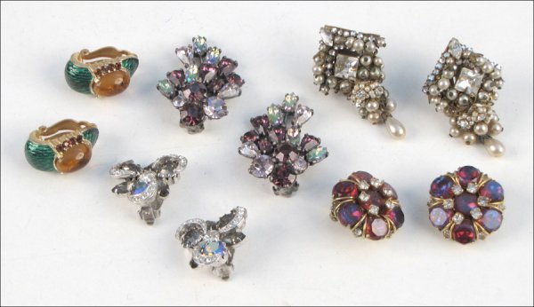 FIVE PAIRS OF SIGNED EARCLIPS.: FIVE PAIRS OF SIGNED EARCLIPS. Comprised of one pair of Schiaparelli purple rhinestone spray earclips, one pair of Trifari green enamel and orange glass earclips, one pair of Eugene faux pearl and rhi
