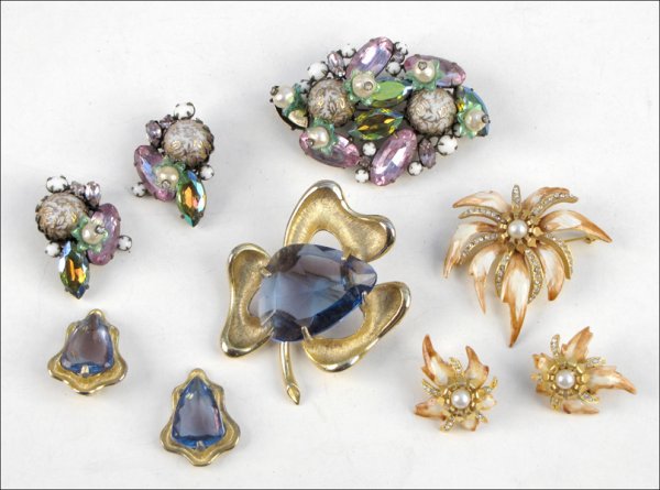 THREE SIGNED DEMI-PARURES.: THREE SIGNED DEMI-PARURES. Comprised of one BSK blue glass clover form brooch and pair of earclips, one Hattie Carnegie orange and white enamel, and faux pearl starburst brooch with earclips, and one 