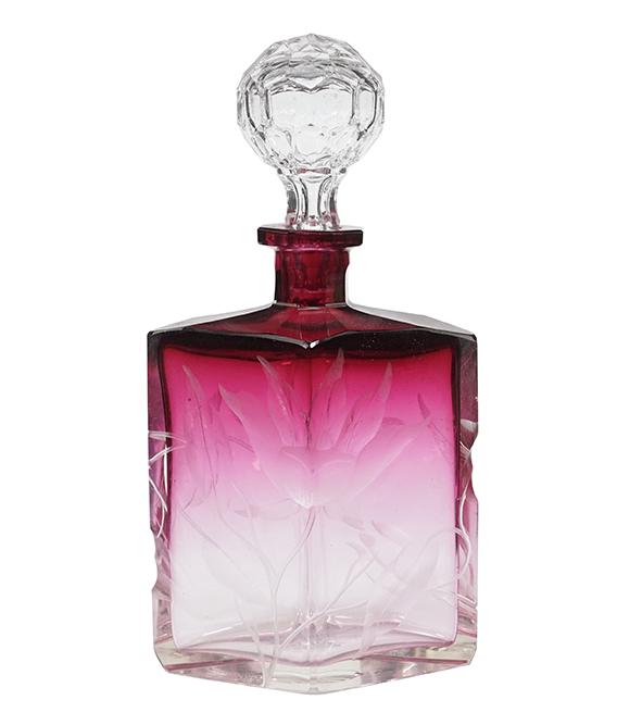 A Moser Cranberry-to-Clear Intaglio Cut Perfume Bottle.: A Moser Cranberry-to-Clear Intaglio Cut Perfume Bottle. Bearing an intaglio foliate motif throughout, the underside is marked 'Made in Czechoslovakia, Moser Karlsbad' Overall height: 9 3/4"