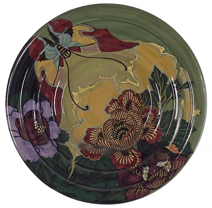 A Rozenburg Earthenware Wall Charger.: A Rozenburg Earthenware Wall Charger. Bearing a decoration of a butterfly and flowers, marked on the reverse with 'Rozenburg den Haag 1009' and a bee Diameter: 15"