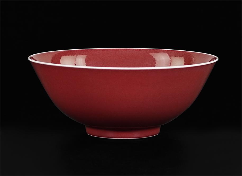 A Chinese Sang de Boeuf Porcelain Bowl.: A Chinese Sang de Boeuf Porcelain Bowl. With a slightly flared rim, bearing an underglaze blue six character Qianlong mark within concentric blue circles on the underside 2 1/2" x 6"
