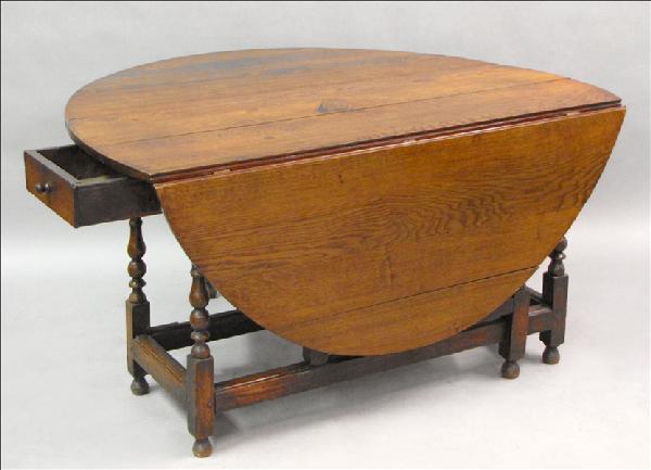 18TH CENTURY ENGLISH TURNED OAK GATELEG TABLE.: 18TH CENTURY ENGLISH TURNED OAK GATELEG TABLE. Of peg construction. Leaf width: 20.5" H: 28.5" W: 54" D: 20"