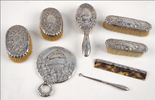 TIFFANY & CO. STERLING SILVER DRESSER SET.: TIFFANY & CO. STERLING SILVER DRESSER SET. Comprised of five brushes, one hand mirror, one button hook, and one comb. All pieces monogrammed. Hand mirror is marked "Tiffany & Co. Makers". All other pi