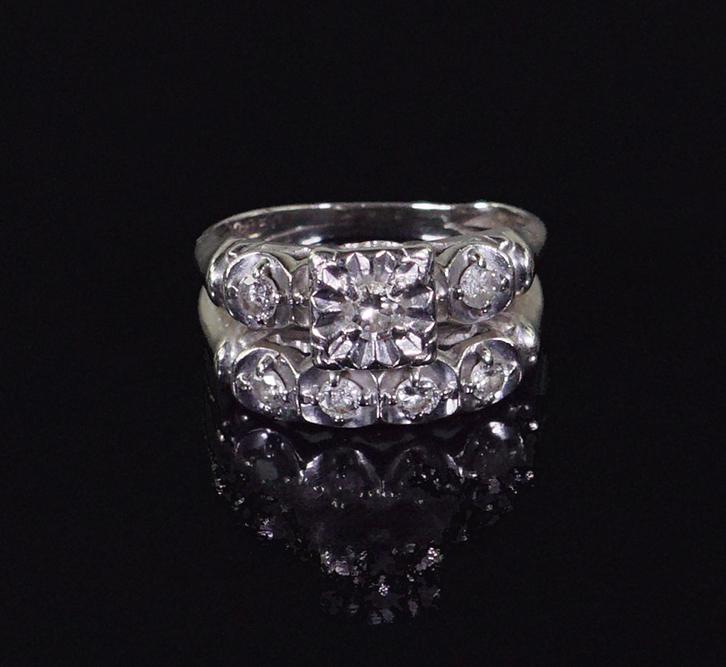 A Diamond Wedding Ring Set.: A Diamond Wedding Ring Set. Comprising two soldered 14 karat white gold rings containing seven round brilliant diamonds Size: 5 1/2 Wt: 5.1 grams