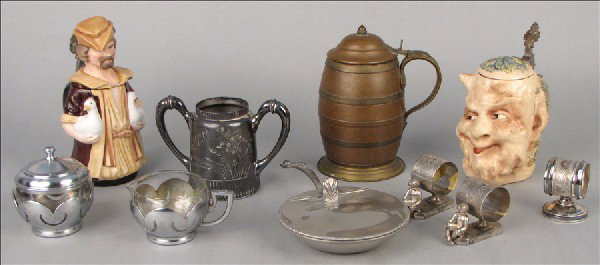 MERKELBACH & WICK CERAMIC SATYR FORM STEIN.: MERKELBACH & WICK CERAMIC SATYR FORM STEIN. Together with a two steins, two silverplate napkins rings, a creamer and sugar, a pewter silent butler, and a silverplate double handled cup