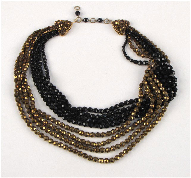 COPPOLA E TOPPO FACETED BLACK AND COPPER GLASS : COPPOLA E TOPPO FACETED BLACK AND COPPER GLASS BEAD NECKLACE. Eight strand necklace bears a partial signature on one side of the clasp Length: clasp to clasp 18.5" chain: 3"
