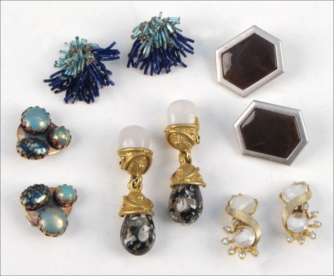 FOUR PAIRS OF SIGNED EARCLIPS.: FOUR PAIRS OF SIGNED EARCLIPS. Comprised of one pair of Yves Saint Laurent brown and silvertone earclips, one pair of Schiaparelli rhinestone earclips, one pair of Hobe blue bugle bead earclips, and o