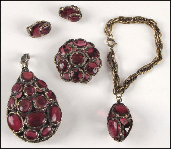 TRIFARI PINK GLASS PARURE.: TRIFARI PINK GLASS PARURE. Comprised of a pendant, pair of earclips, brooch/pendant, and charm bracelet