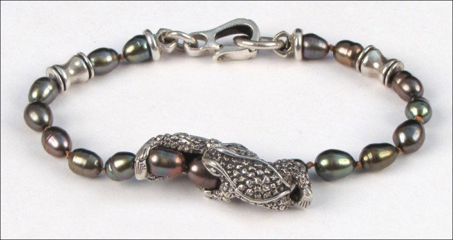 KIESELSTEIN CORD STERLING SILVER AND BLACK PEAR: KIESELSTEIN CORD STERLING SILVER AND BLACK PEARL BRACELET. With a sterling silver frog charm Length: 8.5"
