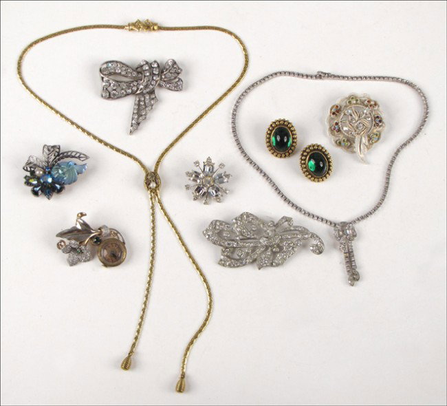 YVES SAINT LAURENT GREEN GLASS EARCLIPS.: YVES SAINT LAURENT GREEN GLASS EARCLIPS. Together with five rhinestone brooches, one Otis rhinestone and sterling silver necklace, and a rhinestone lapel watch