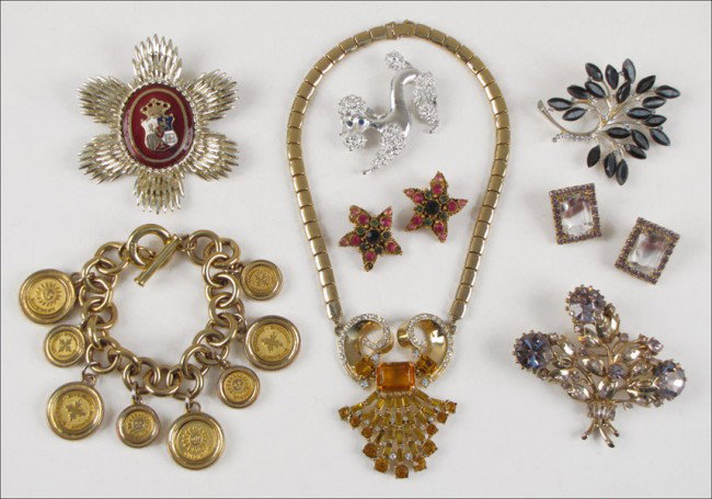 AN UNSIGNED WHITE AND AMBER RHINESTONE NECKLACE: AN UNSIGNED WHITE AND AMBER RHINESTONE NECKLACE. Together with a Givenchy charm bracelet, a Hollycraft purple rhinestone floral brooch, a pair of Kramer purrple rhinestone earclips, a pair of Florenza